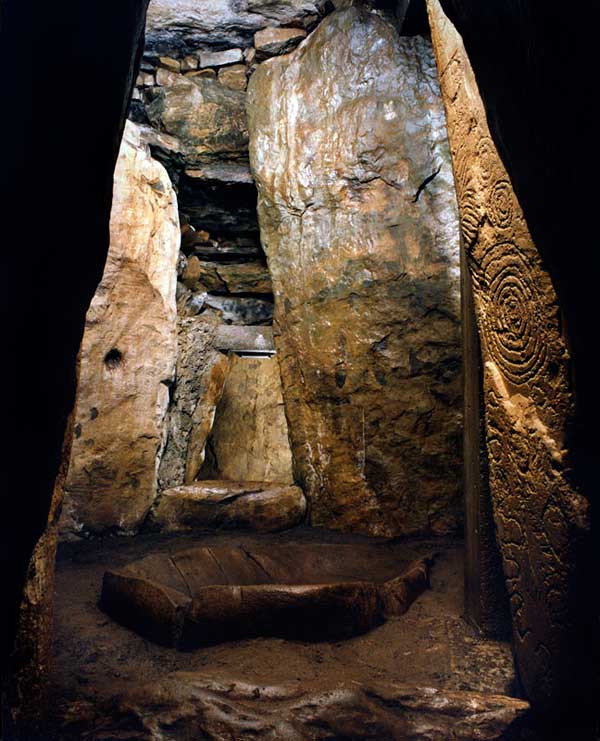 The main chamber at Dowth is constructed of massive slabs. The basin is one of the largest in the Boyne Valley. The stone on the right is covered with engravings.