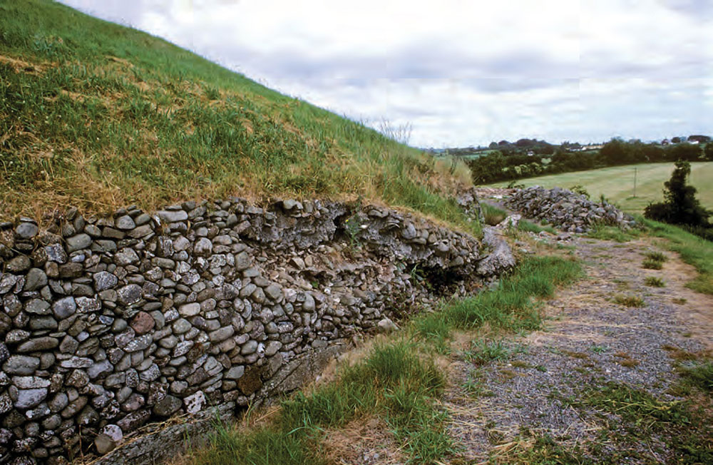 The back of Newgrange showing the collapsed 1880's mortared revetment caused by a back-up of water caused by the reinforced concrete additions to the front of the monument. The image is taken Newgrange revisited: new insights from excavations at the back of the mound in 1984–8 by Ann Lynch.