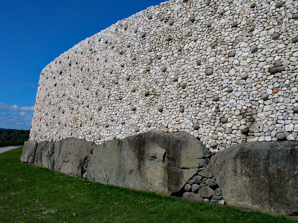 Michael O'Kelly and the O.P.W. reconstructed what they believed was a collapsed wall which had supported the quartz facade at Newgrange.