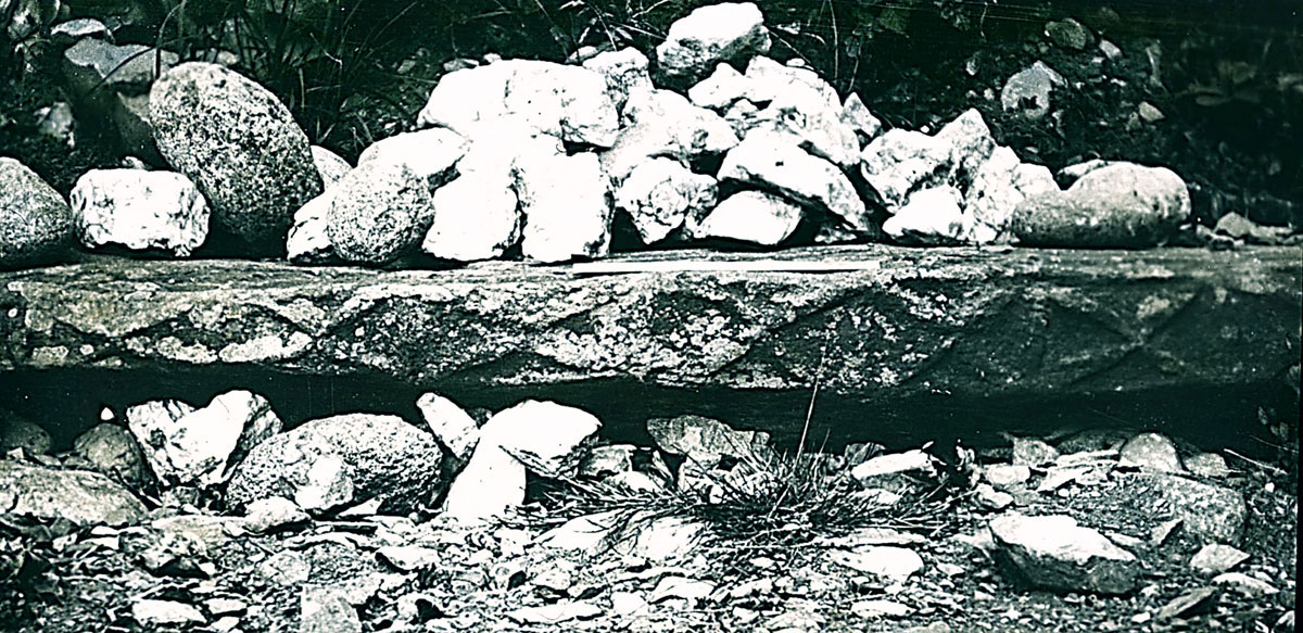 An old photo of the Roofbox lintel from before the mound was excavated.