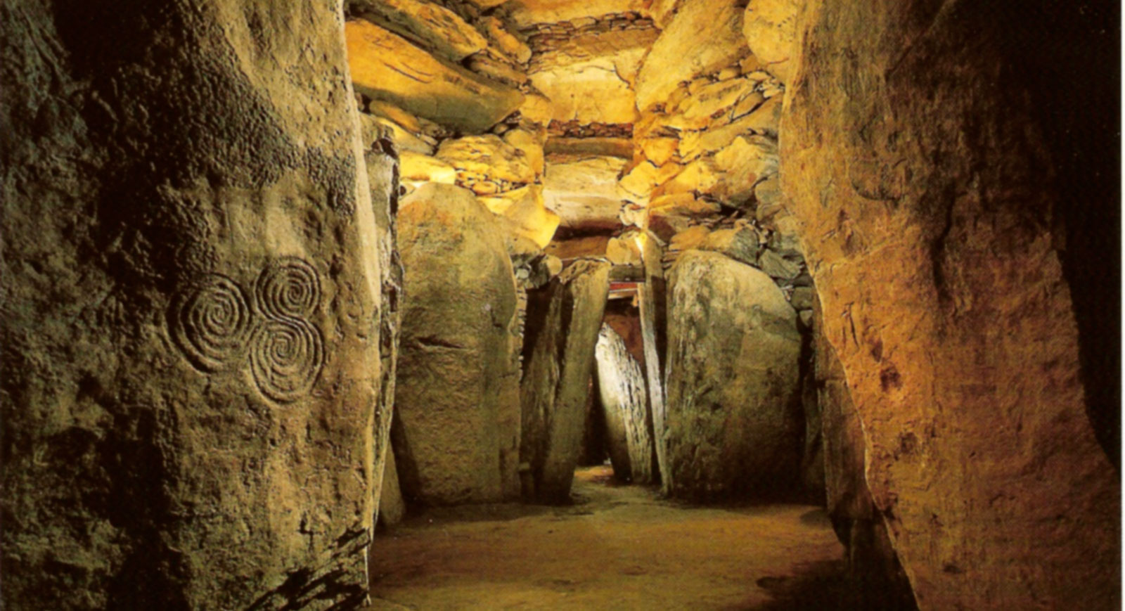 The view from the end recess looking across the chamber and down into the passage of Newgrange. This photograph was used for the cover of Professor Michael O'Kelly's book on Newgrange. Image © Office of Public Works.
