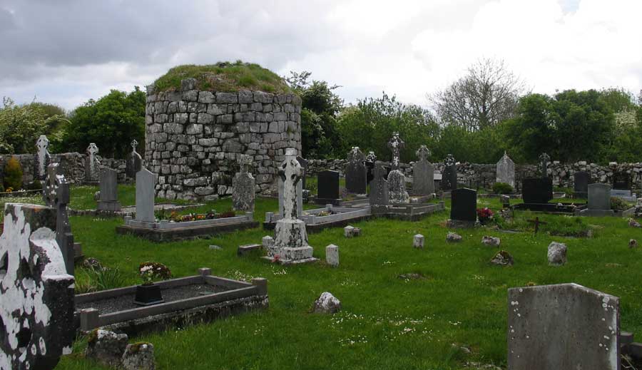 The base of a small round tower at Kilnaboy church. 