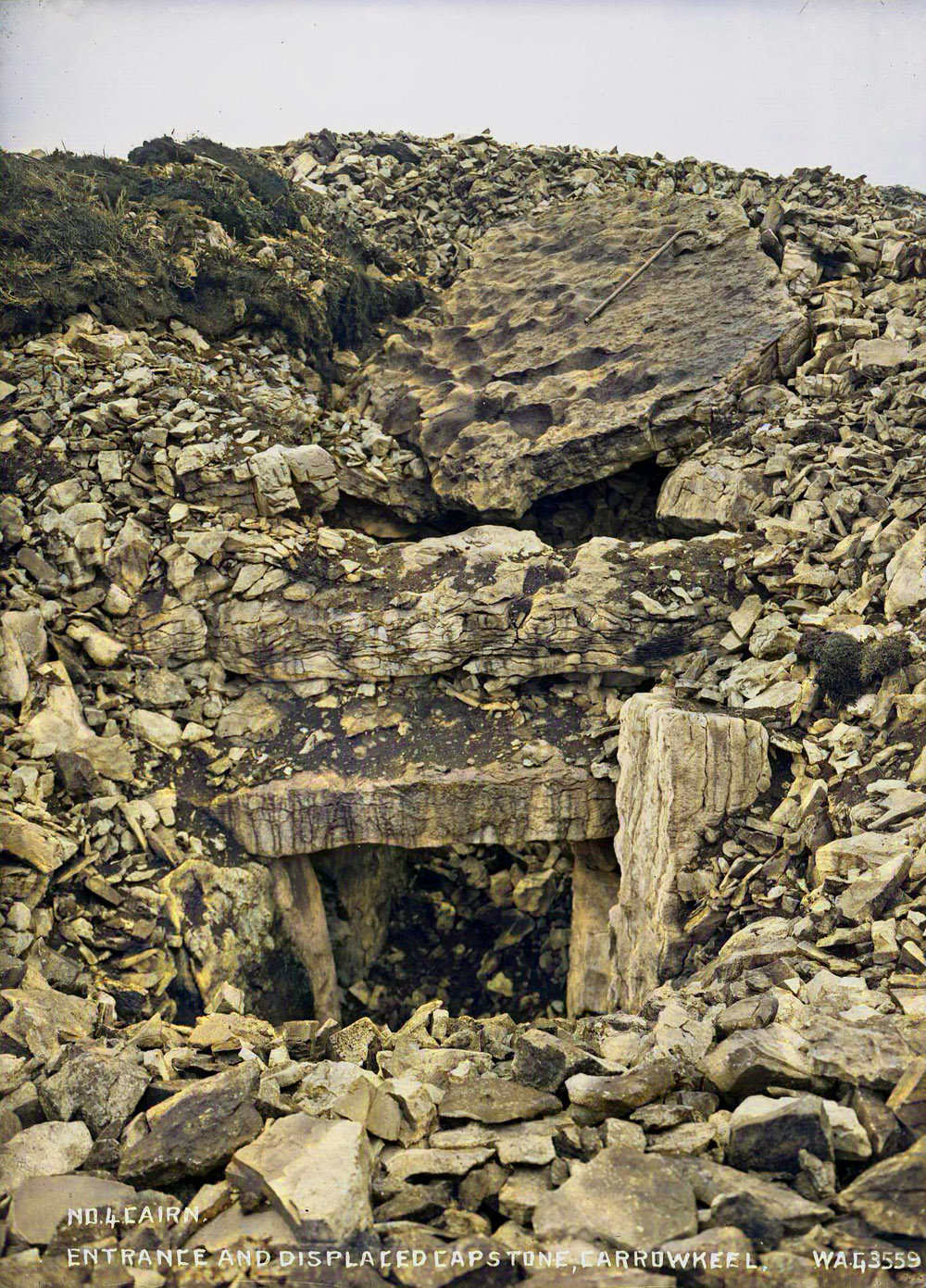 The capstone of Cairn F halts excavation of the chamber in June, 1911. Photograph by William A. Green.