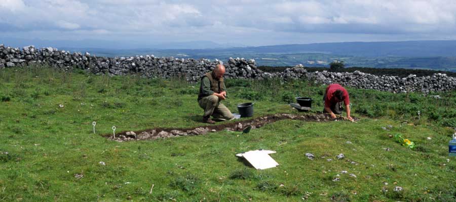 Stefan Bergh and a student excavating a 6 x 1 meter trench across one of the Doonaveeragh huts in 2003.