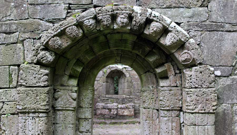 A
    heavily carved and much eroded classical Irish early Christian doorway leads into the small church. 