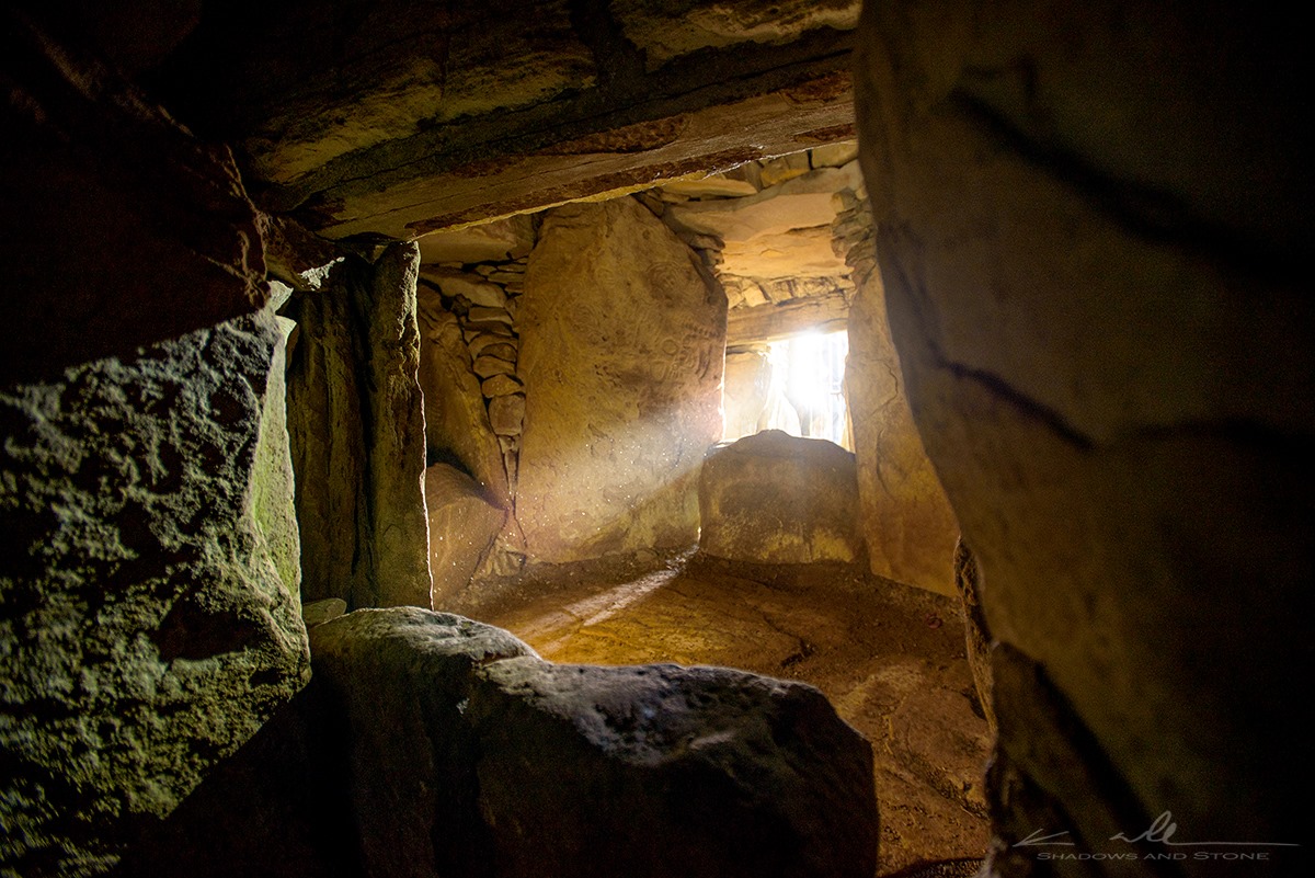 Sunbeam interacts with megalithic art within the chamber at Cairn T. Photograph © Ken Williams, Shadow and Stone.