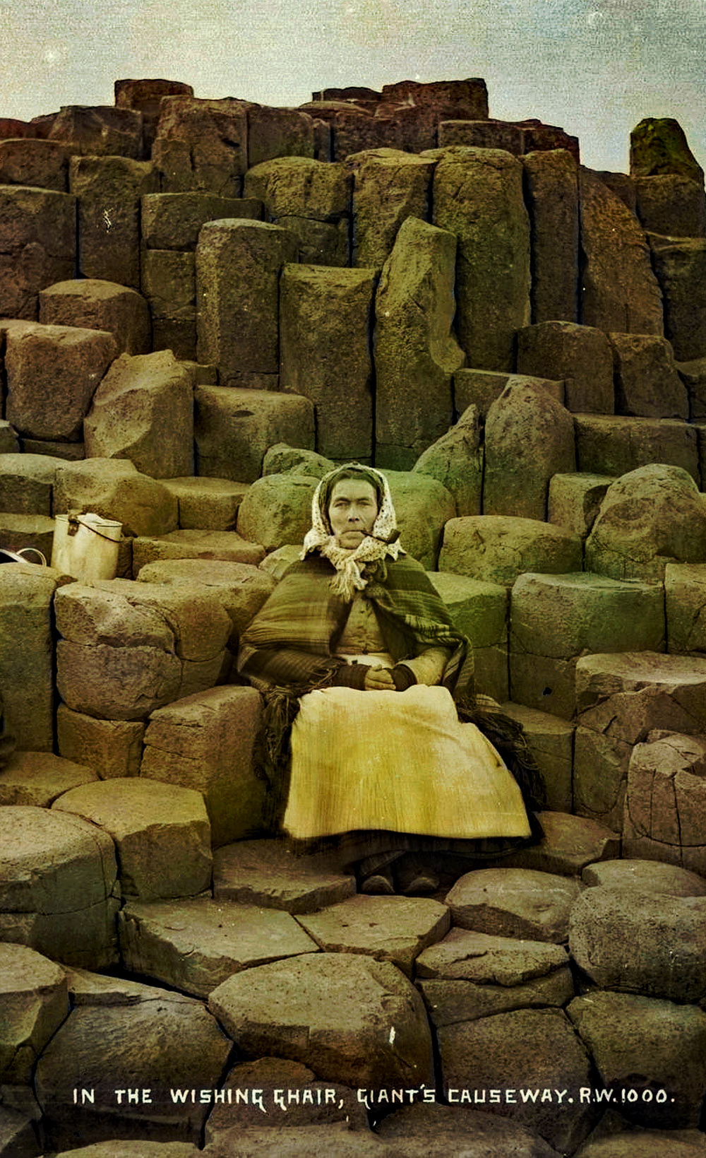 A old woman sitting on the Wishing Chair at the Giant's Causeway.