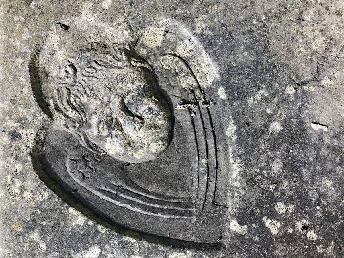 A carved angel on the corner of a grave slab in Sligo Abbey.